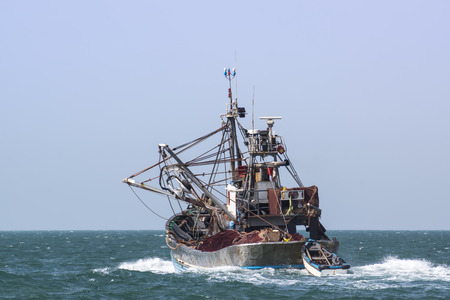 A fishing boat is at sea fishing. Sunny.の写真素材