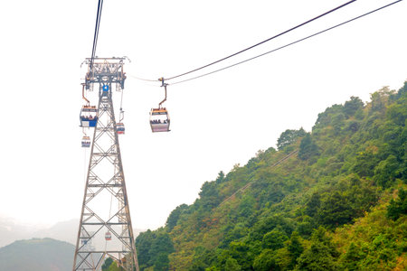 Cableway in the mountains. Hong Kong. China. Fog.の写真素材