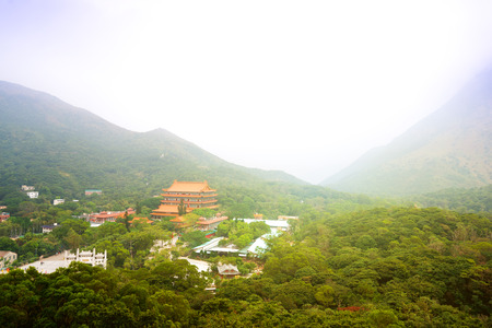 Chinese Buddhist monastery in the mountains. The view from the platform Tian Tan Buddha Statue.の写真素材