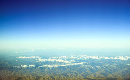 Aerial view of snow covered mountains. Clear sky.の写真素材