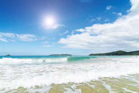 Waves in the sea and sand on the beach. Wave with foam and splash.の写真素材