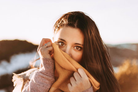 Girl covering herself with a handkerchiefの写真素材