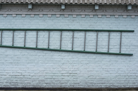 Blank dirty grunge wall with ladderの写真素材