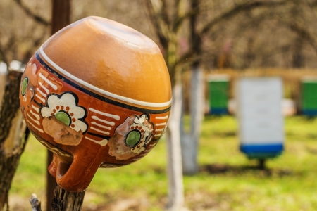 Old traditional clay jug hanging on the wooden fenceの写真素材