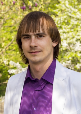 happy guy in the park a white suit and purple shirtの写真素材