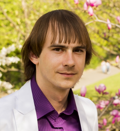 happy guy in the park a white suit and purple shirtの写真素材