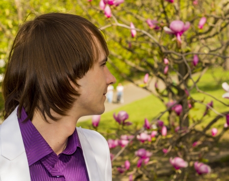  guy in the park a white suit and purple shirtの写真素材