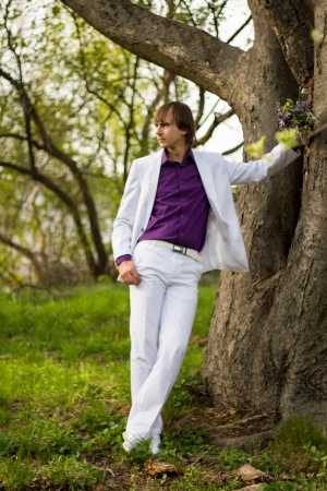 Handsome man wearing bouquet of flowers の写真素材