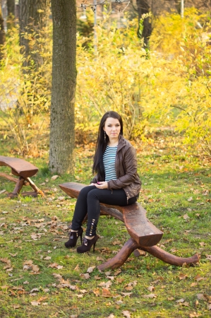 girl sitting on bench outdoorsの写真素材