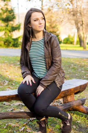 girl sitting on bench outdoorsの写真素材