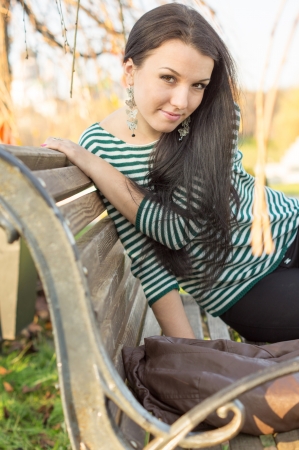 girl sitting on bench outdoorsの写真素材