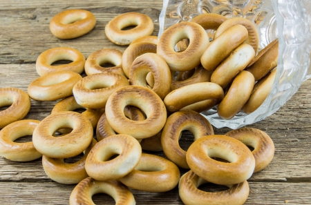 Closeup of a group of assorted bagels on a wood table top with burlap in the backgroundの写真素材