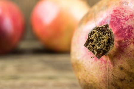 Pomegranate isolated on wooden backgroundの写真素材