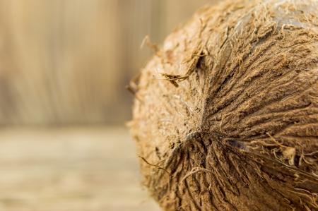 Whole fresh coconut over wooden backgroundの写真素材