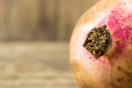 Pomegranate isolated on wooden backgroundの写真素材
