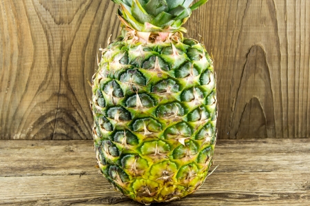 Pineapples on wooden grunge backgroundの写真素材