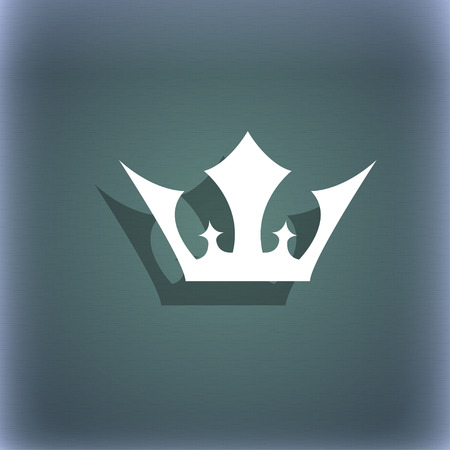 Crown icon symbol on the blue-green abstract background with shadow and space for your text. illustrationの写真素材