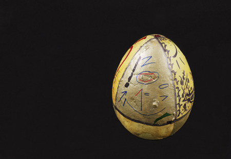 Big egg with with cryptic information written on it, isolated on black.の写真素材