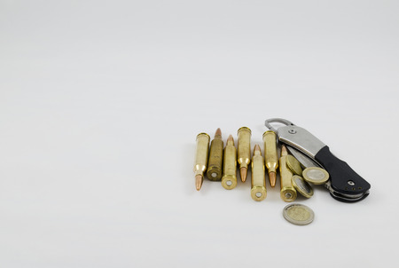 Ammunition money and a pocket knife isolated on whiteの写真素材