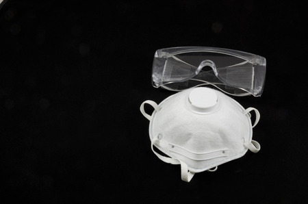 Protection equipment for eyes and respiration isolated on blackの写真素材