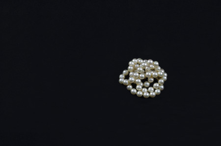 Coiled Pearl necklace isolated on blackの写真素材