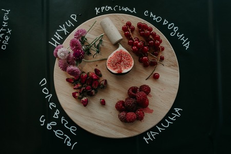 Fresh berries on a board and wooden table.の写真素材