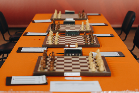 Chess pieces on a boart ready to play a game. Wood pieces of a game of chess on a board.の写真素材