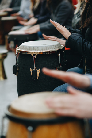 a large group of people play with African drums for the first timeの写真素材
