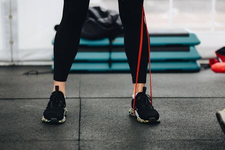 Exercising with yoga belt. Close-up of womans leg during exercising with yoga beltの写真素材