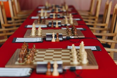 Chess pieces on a boart ready to play a game. Wood pieces of a game of chess on a board.の写真素材