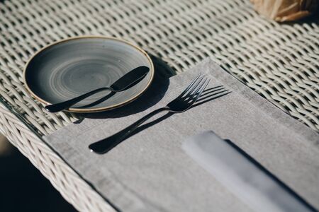 tableware Glasses, flower fork, knife served for dinner in restaurant with cozy interiorの写真素材