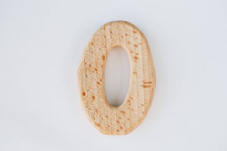 wooden figure number zero isolated on white backgroundの写真素材