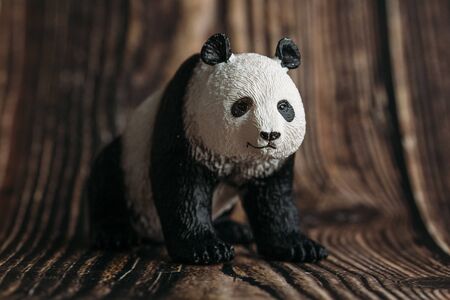 toy Panda figurine on wooden background.の写真素材