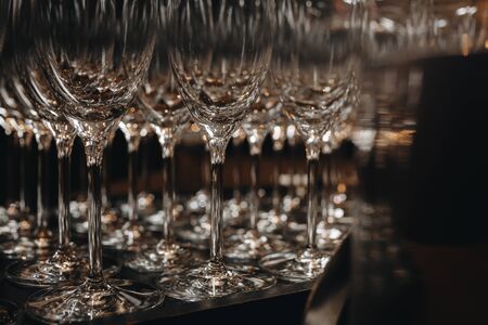 Empty clean champagne glasses on counter in barの写真素材