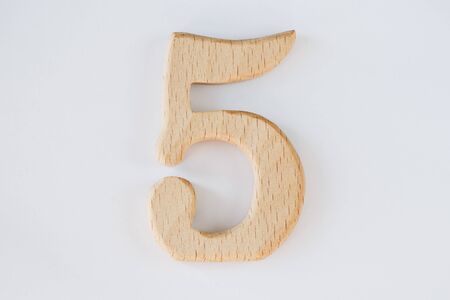 wooden figure number five isolated on white backgroundの写真素材