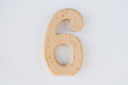 wooden figure number six isolated on white backgroundの写真素材