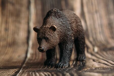figure of a toy brown bear on a wooden background.の写真素材