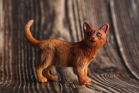 figure of a toy cat on a wooden background.の写真素材