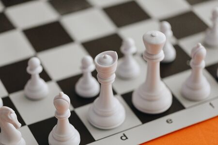 Staunton White Chess Pieces on Chess Board. A set of traditional Staunton boxwood white chess pieces lined up on a board ready to play.の写真素材