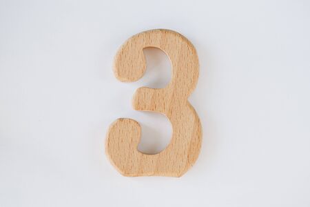 wooden figure number three isolated on white backgroundの写真素材