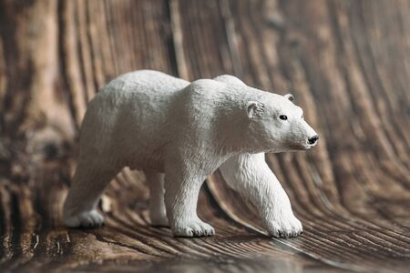 figure of a toy polar bear on a wooden background.の写真素材