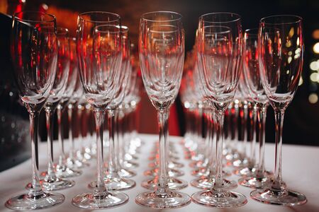 Empty clean champagne glasses on counter in barの写真素材
