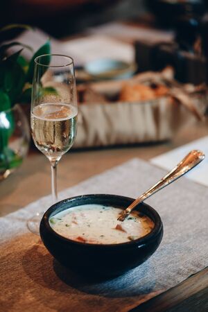 tableware Glasses, flower fork, knife served for dinner in restaurant with cozy interiorの写真素材