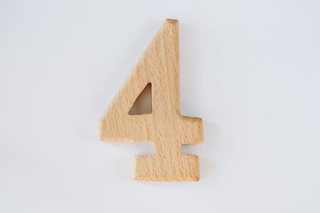 wooden figure number four isolated on white backgroundの写真素材