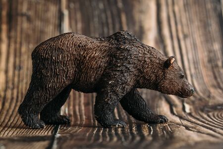 figure of a toy brown bear on a wooden background.の写真素材