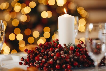 Close up of a wax candle light with bokeh on the table before a date.の写真素材