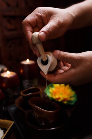close-up of the masseur's hands, a drop of massage oil flows down his hand.の写真素材