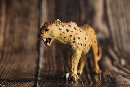 figure of a toy Cheetah on a wooden background.の写真素材