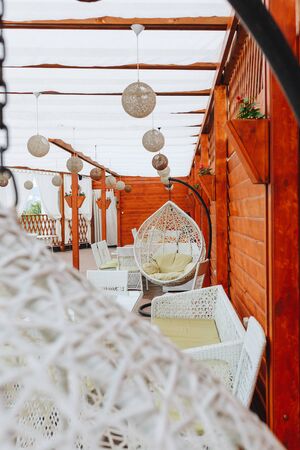 Wood table and chair at summer terrace restaurant, cafe in hotel.の写真素材