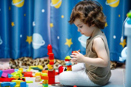 Little autistic boy playing with cubes at homeの写真素材